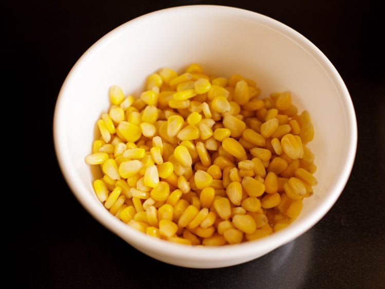 boiled corn kernels in a mixing bowl. 