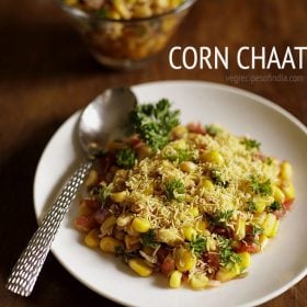 corn chaat served on a white plate with a spoon in it with text layovers.