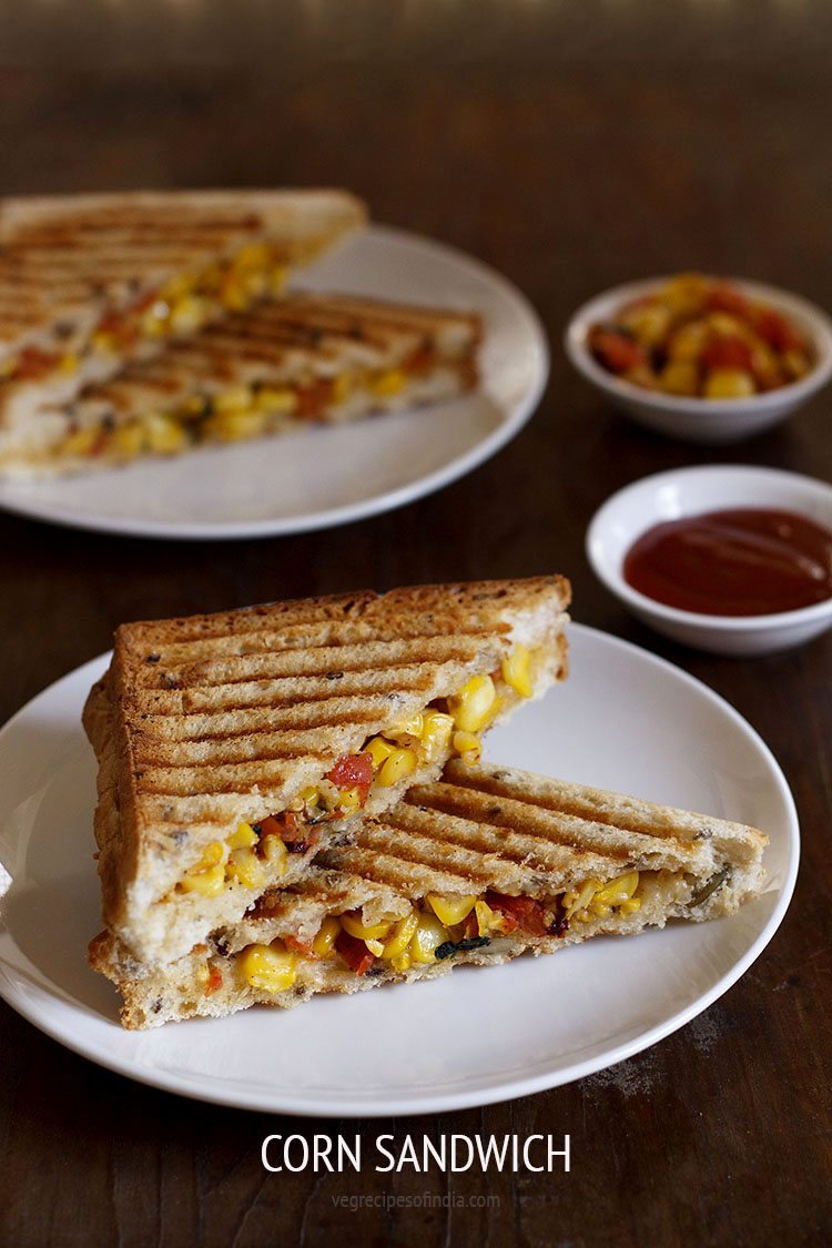 cheese corn sandwich served on a white plate with tomato ketchup