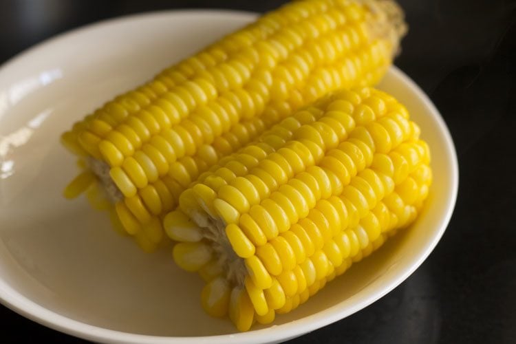 boiled corn cooling on a plate