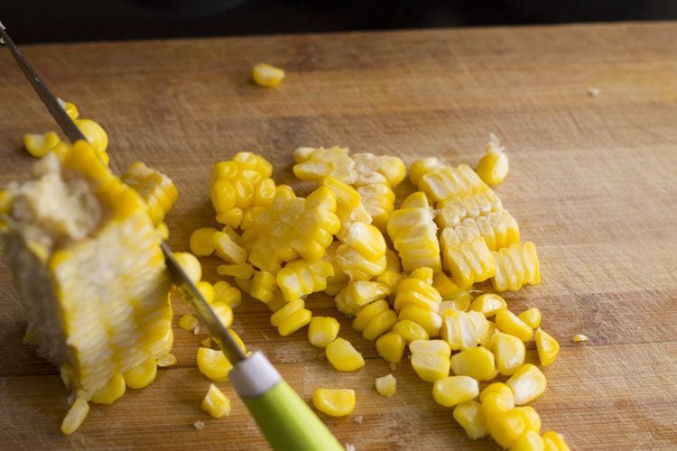 knife removing corn kernels from the cob