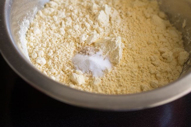 gram flour and baking soda and hing in a bowl