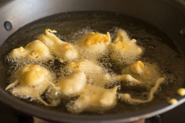 cauliflower pakora added to hot oil