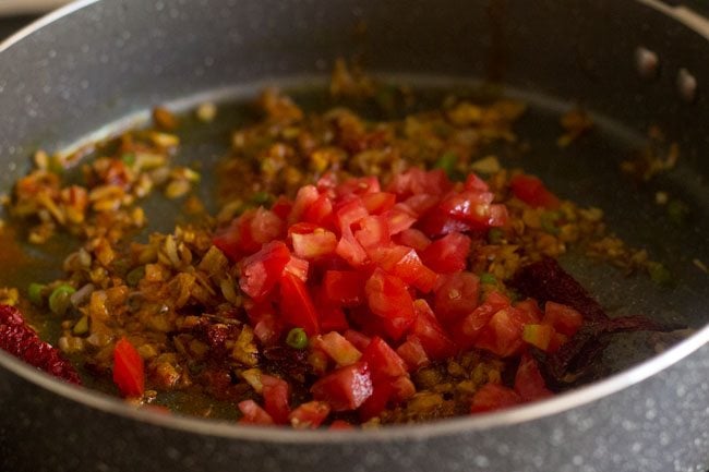 chopped tomatoes in pan.