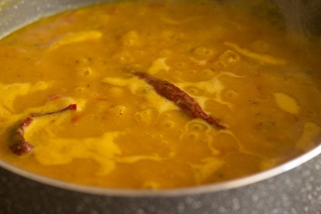 masoor dal or red lentils simmering in pan.