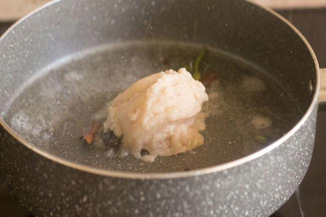 adding prepared onion paste in pan 
