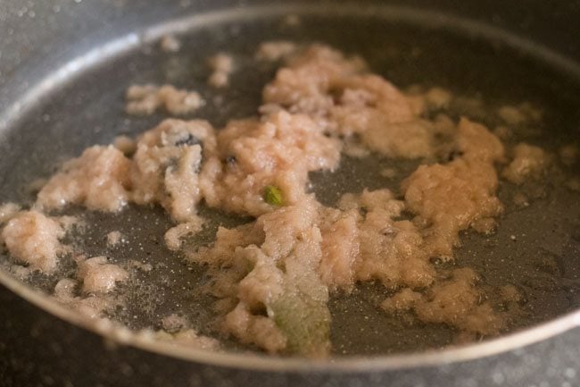 frying onion paste in pan