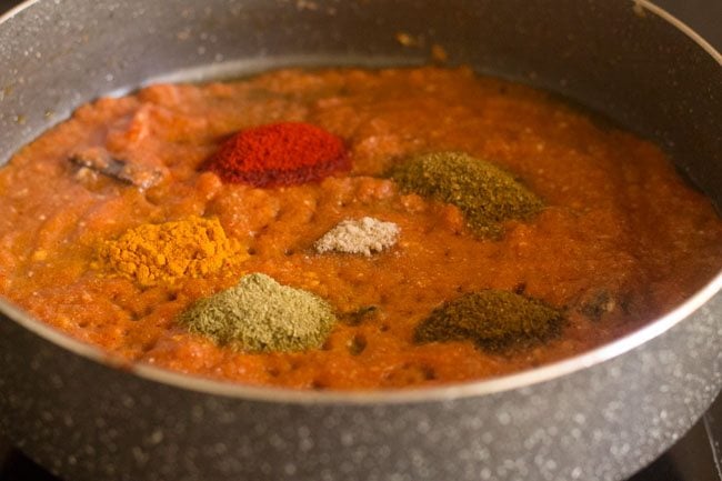 adding turmeric powder, red chili powder, coriander powder, fennel powder, garam masala powder and asafoetida in pan