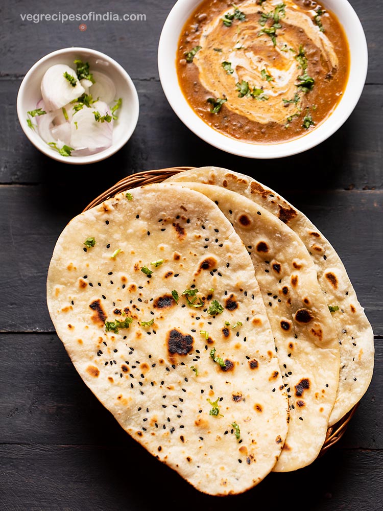 naan bread served on a tray with dal makhani