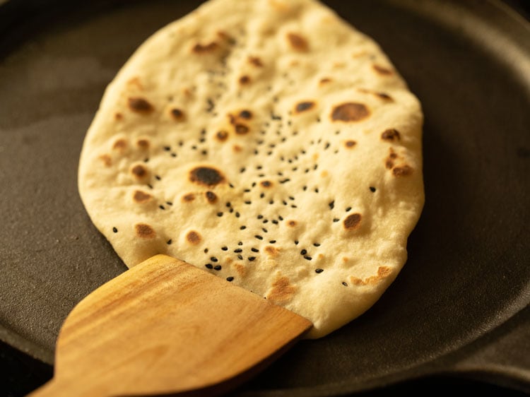 naan bread edges by pressing with spatula