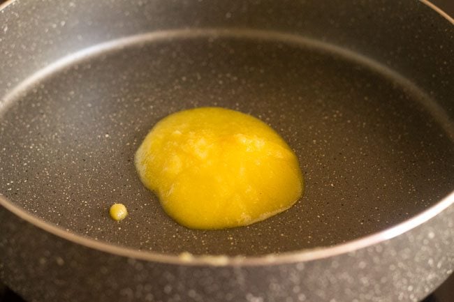 heating ghee in a thick bottomed pot. 