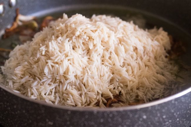 drained basmati rice added to the pot. 