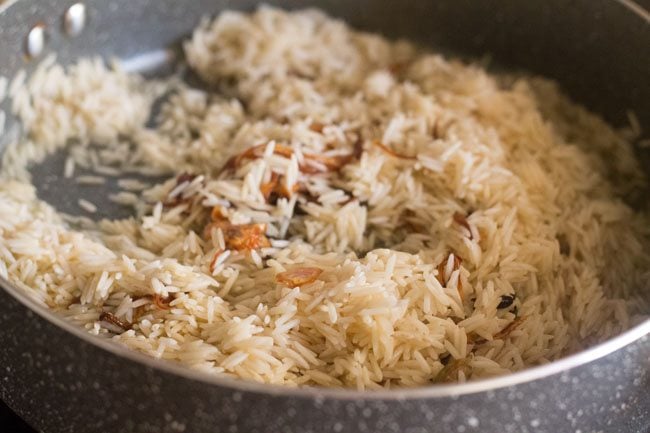 stirring the rice in the pot. 