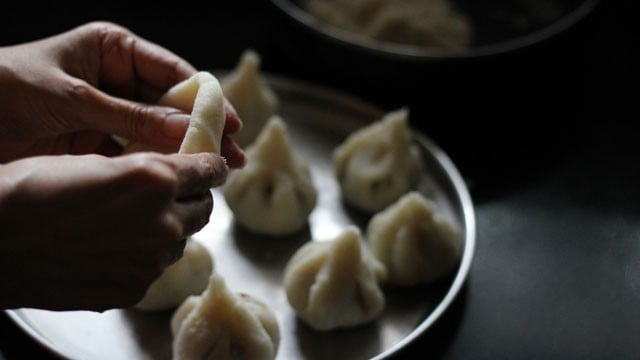 pressing edges of dough ball