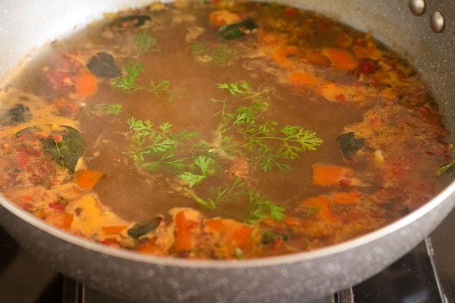 garnish tamarind rasam with coriander leaves