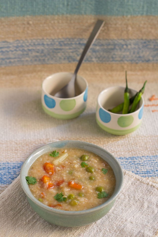 dalia khichdi served in a bowl with a spoon in it.