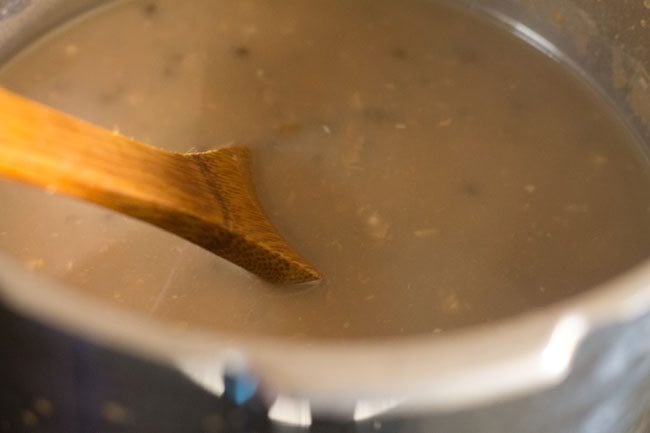 mashing cooked lentils