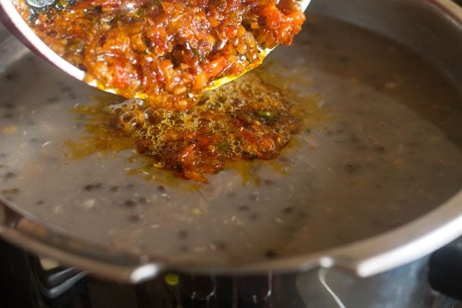 tempering mixture added to cooked lentils