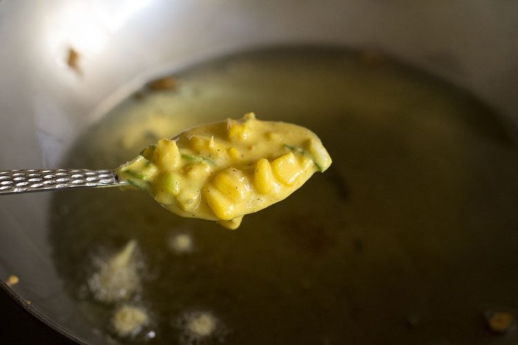 frying corn pakora in oil