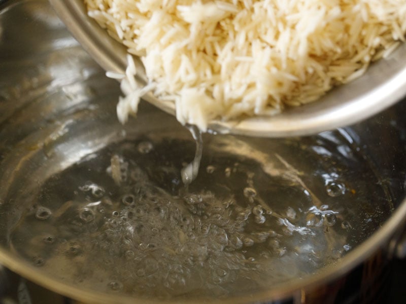 soaked rice being added to water