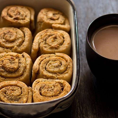 garlic rolls in baking pan with a side of tea