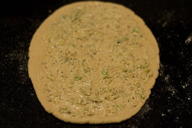 spread 1/3 of the garlic butter mixture over the rolled out dough.