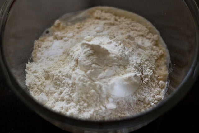 adding dry ingredients to yeast mixture.