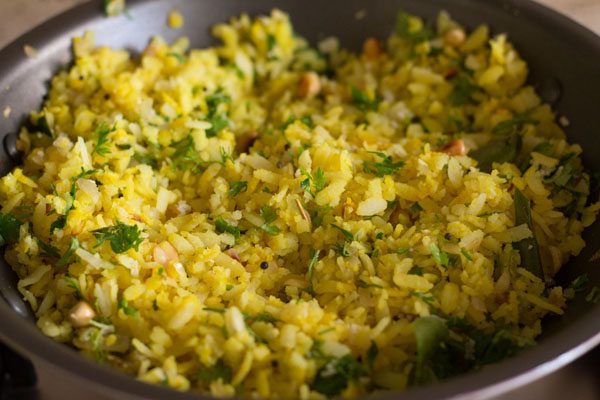 foglie di cocco e coriandolo mescolate delicatamente e kanda poha pronto da servire