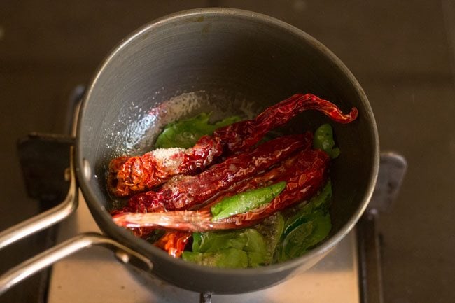 adding dry red chilies curry leaves and hing