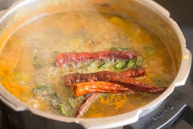 pour the tempering mixture on the sambar