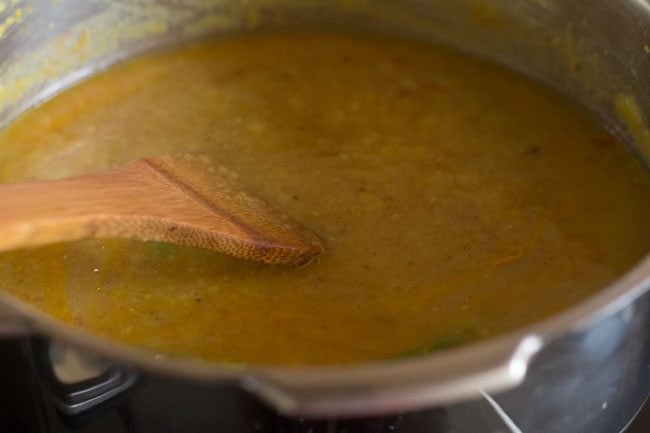 mixing spices in the dal