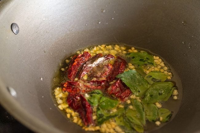 adding dried red chilies, curry leaves and asafoetida 