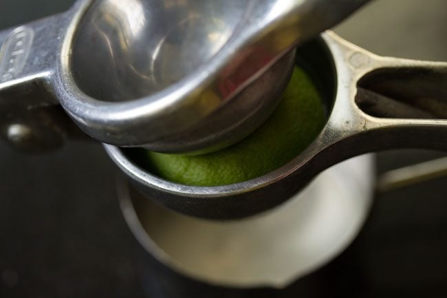 squeezing lemon juice to make lemon rice recipe