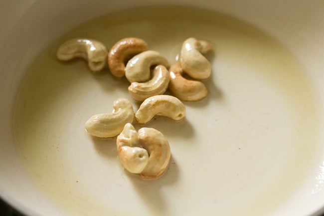 frying cashews until golden color in oil in the pan