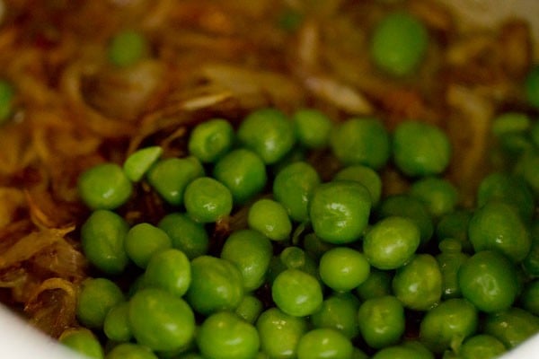 adding green peas