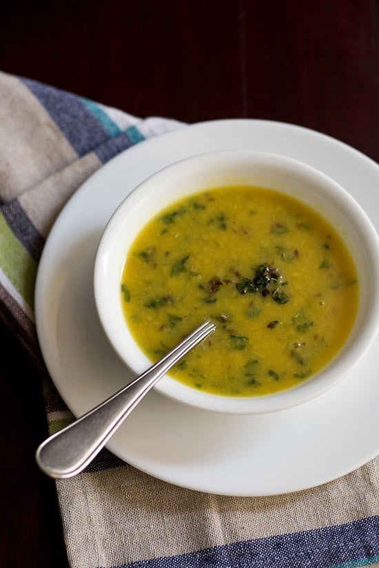 methi dal served in a white bowl with a spoon