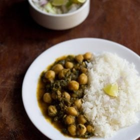 palak chole served on a white plate with steamed rice.