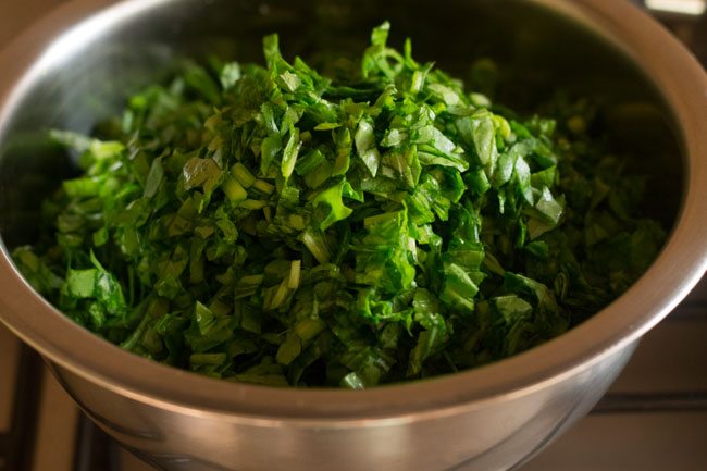 chopped spinach leaves in the pan