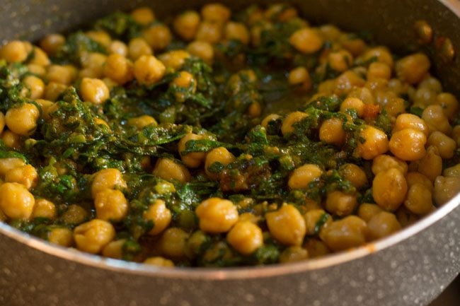 mixing chickpeas with palak mixture