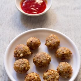 sabudana pakora served with tomato sauce on a white round plate