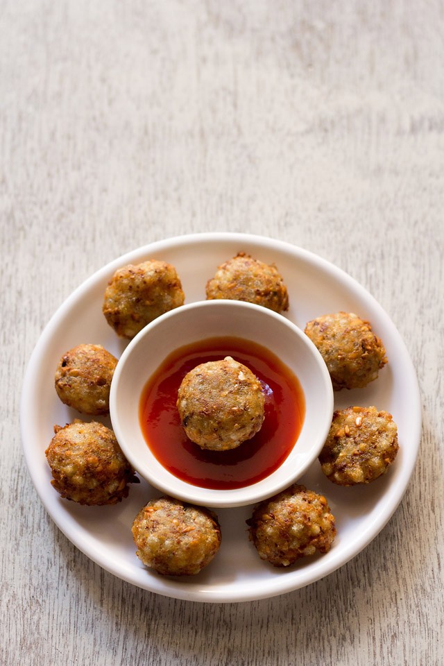 sabudana pakora served with tomato sauce on a white round plate