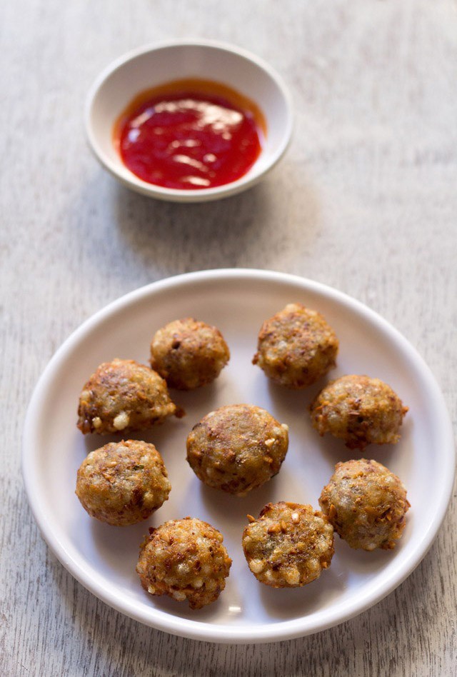 sabudana pakora served with tomato sauce on a white round plate