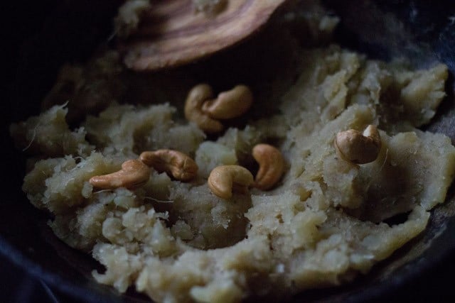 fried cashews added to cooked shakarkandi ka halwa. 