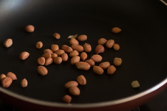 dry roasting peanuts in a pan.