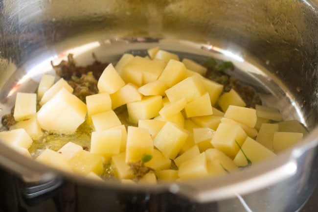 cubed potatoes added in the pan. 