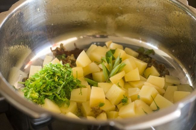 curry leaves and coriander leaves added to the potatoes. 