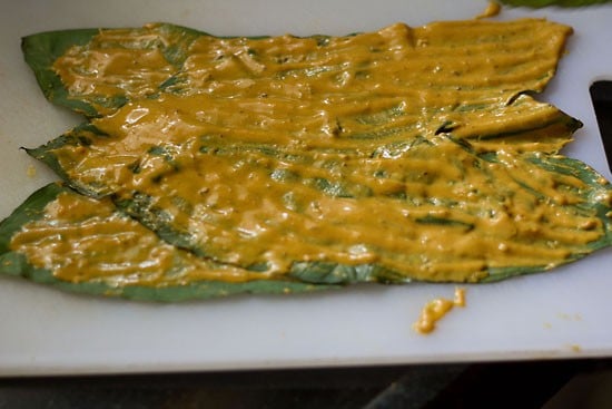 covering the leaves with the batter for making pathrode. 