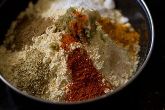 ingredients for batter added in a mixing bowl for patra recipe. 