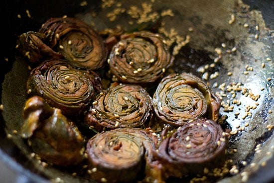 Add the sliced colocasia rolls and saute