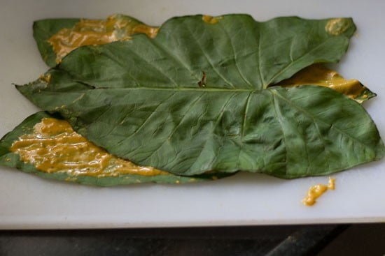 placing colocasia leaves on top for making pathrode. 